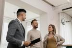 A couple looks at a house with a rental agent