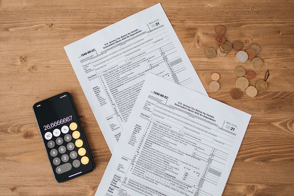 tax forms next to a calculator