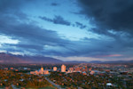 Aerial view of downtown Salt Lake City and the surrounding valley and Wasatch Mountains at sunset.