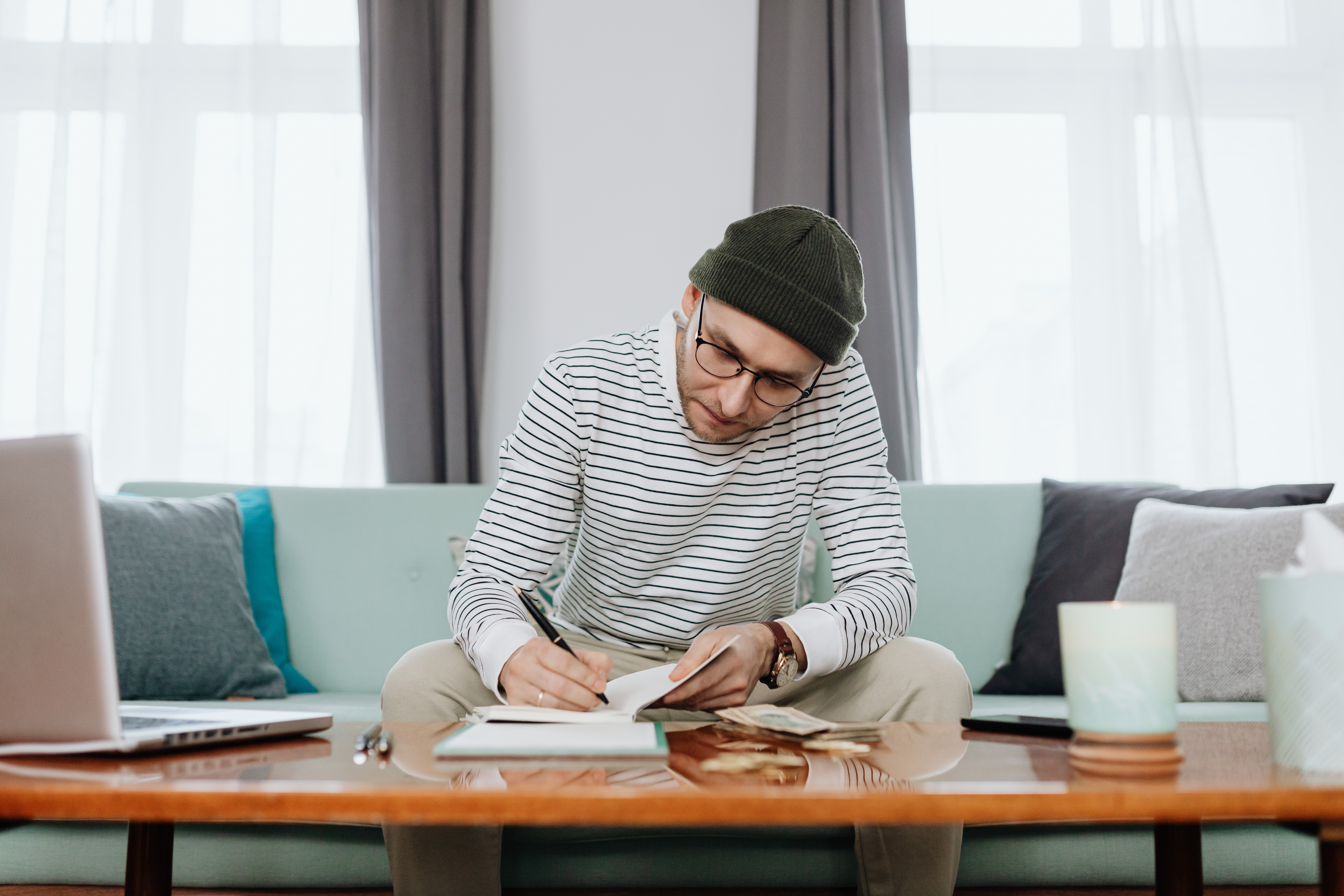 a man sitting on a couch budgeting