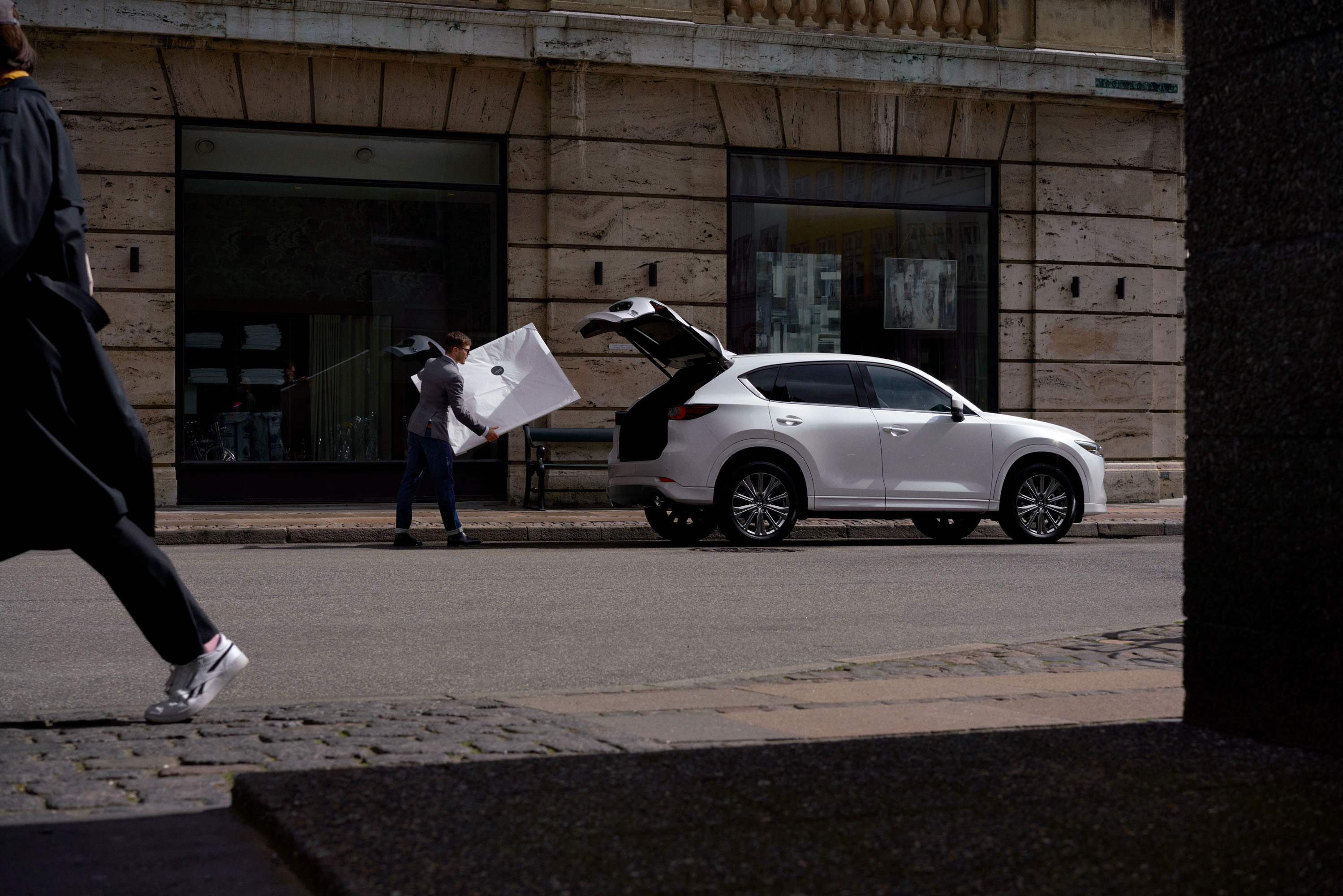 a man loading the trunk of a 2022 CX-5 2.5 Turbo Signature