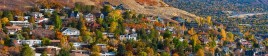 Houses spread across a mountainside during the fall