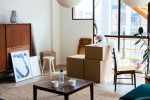 View of downtown apartment from the inside with packing boxes in front of furniture