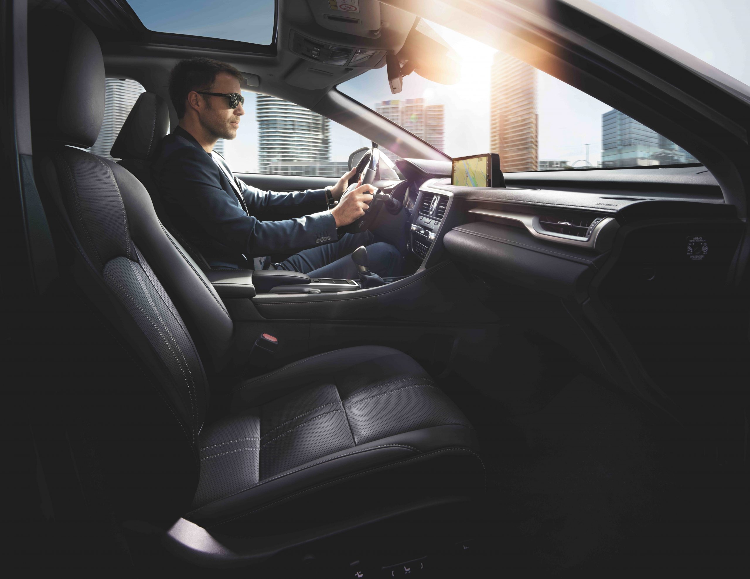 a man in the front seat of a 2022 Lexus RX 450h