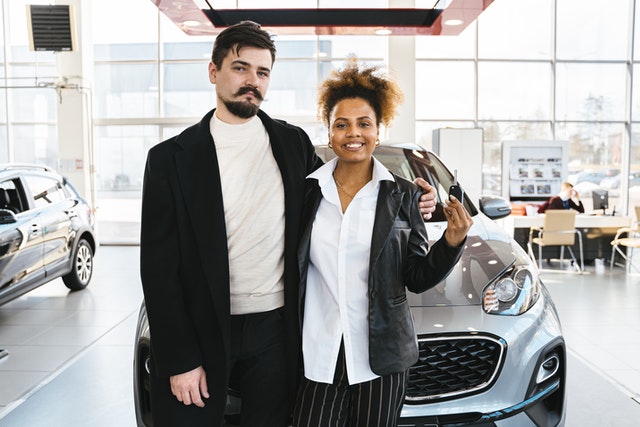 a man and woman purchasing a new car