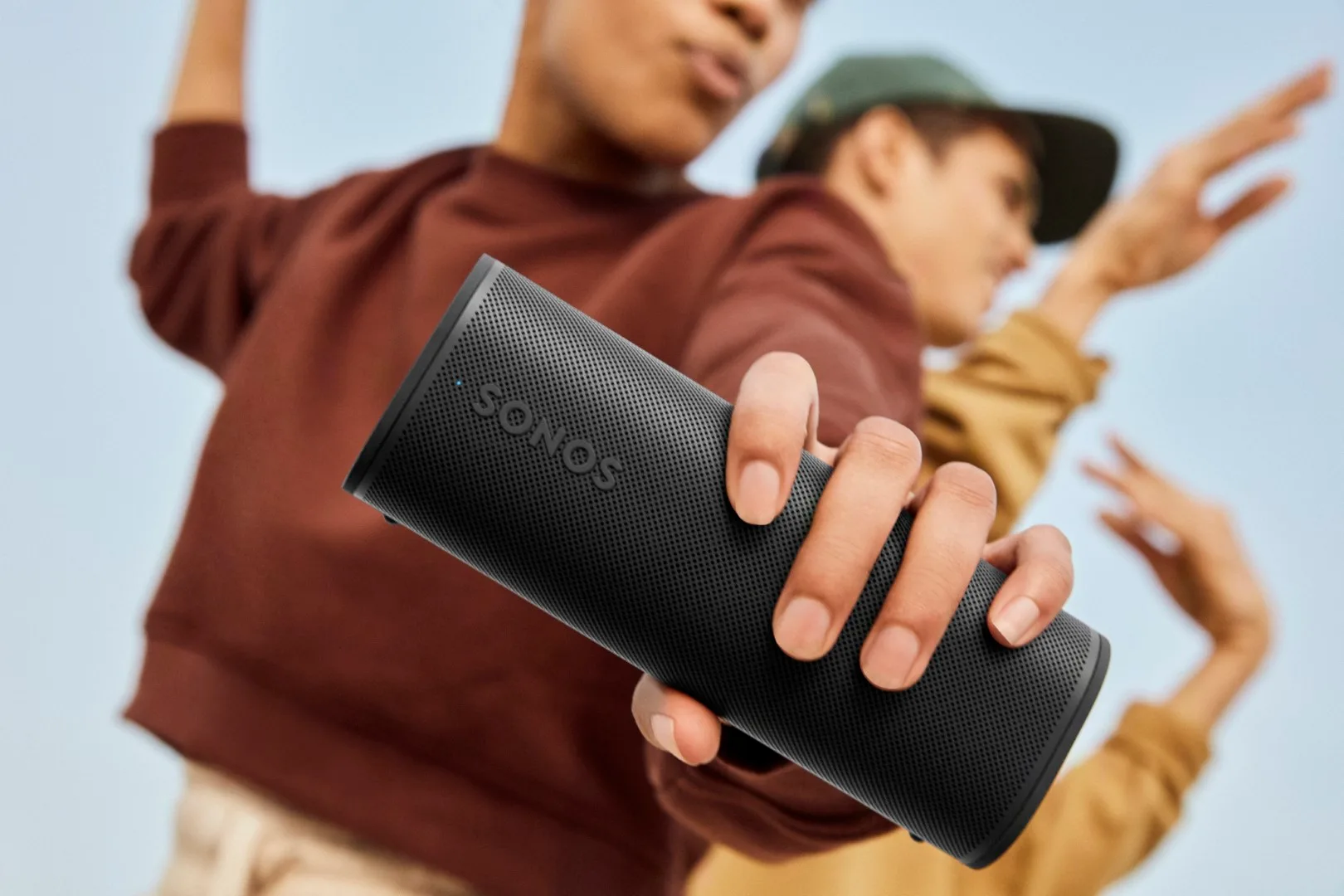 A person holding the new Sonos Roam 2 loudspeaker.