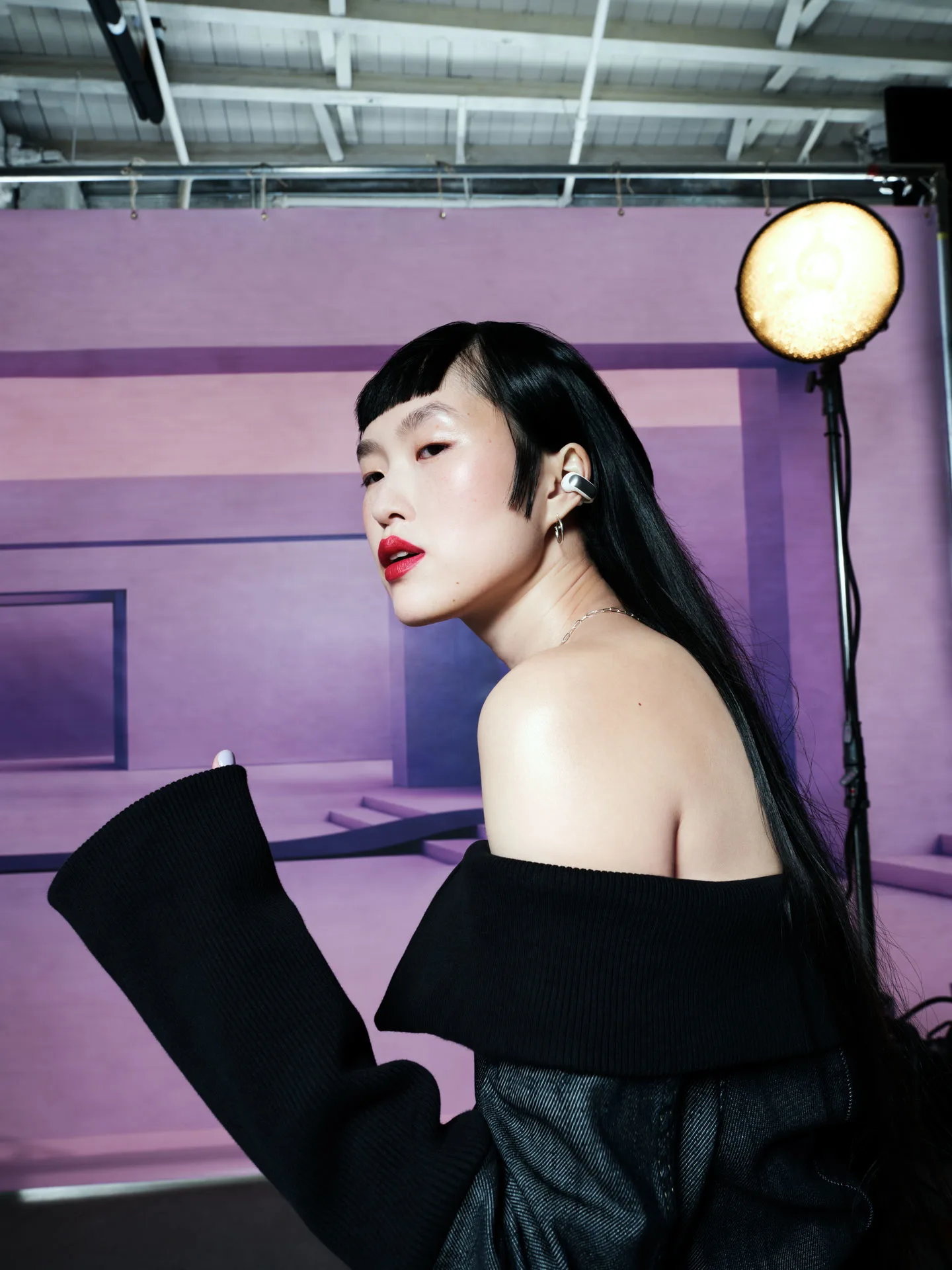 A woman wearing Bose Open Ultra Earbuds.
