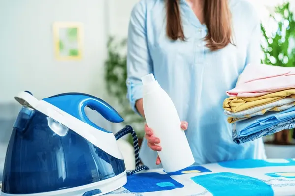 closeup-woman-standing-near-ironing-600nw-1908714649