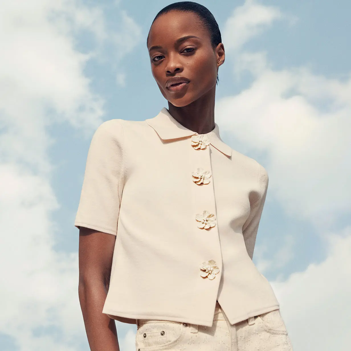 Woman wearing cream cardigan and wide-leg trousers