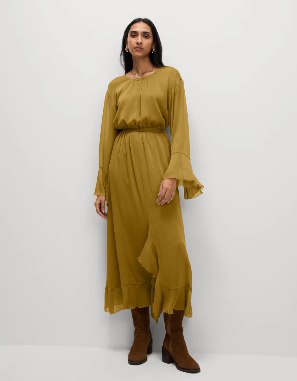 Woman wearing olive green chiffon maxi dress at M&S