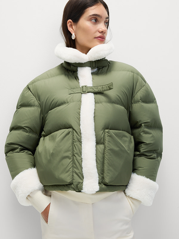 Woman wearing green feather and down padded jacket
