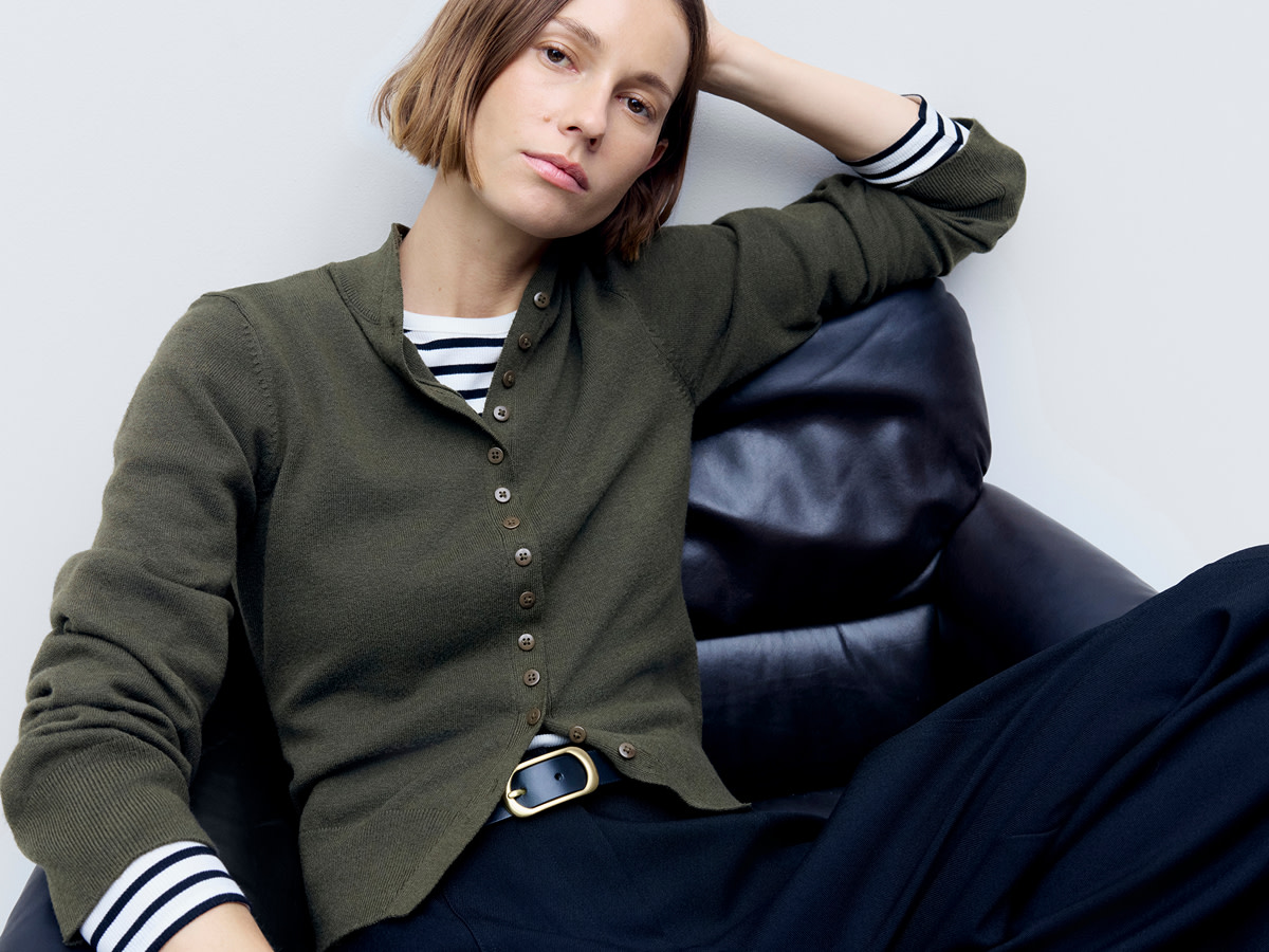 Woman wearing green cardigan over striped top