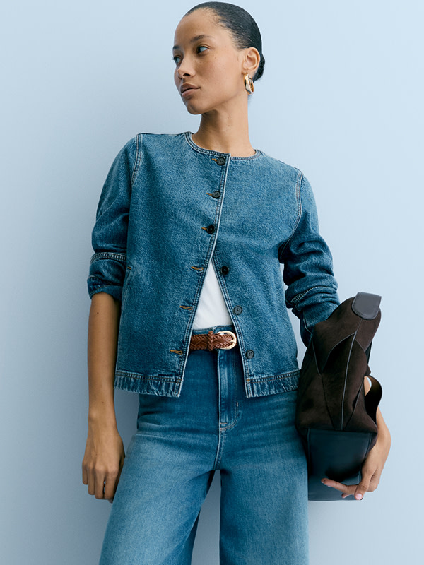 Woman wearing blue denim jacket and jeans 