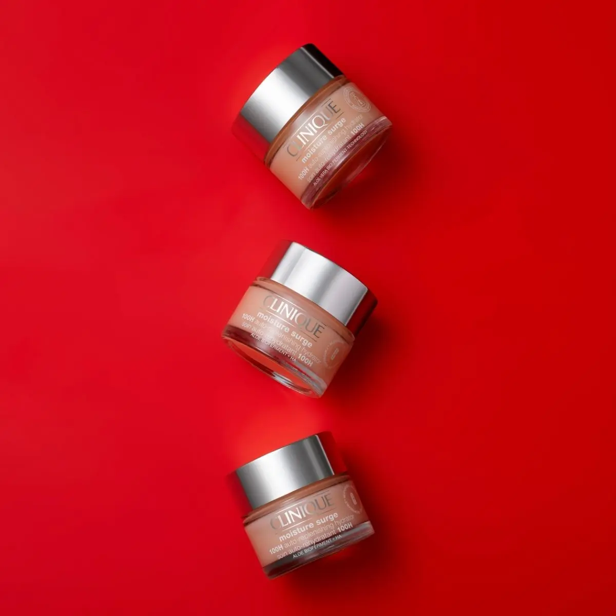 Three bottles of Clinique moisture surge moisturiser