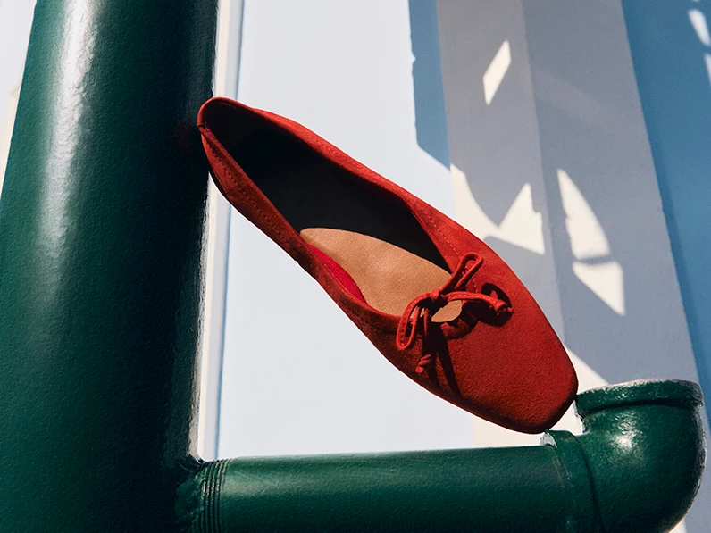 Red suede ballet flats with bow detail