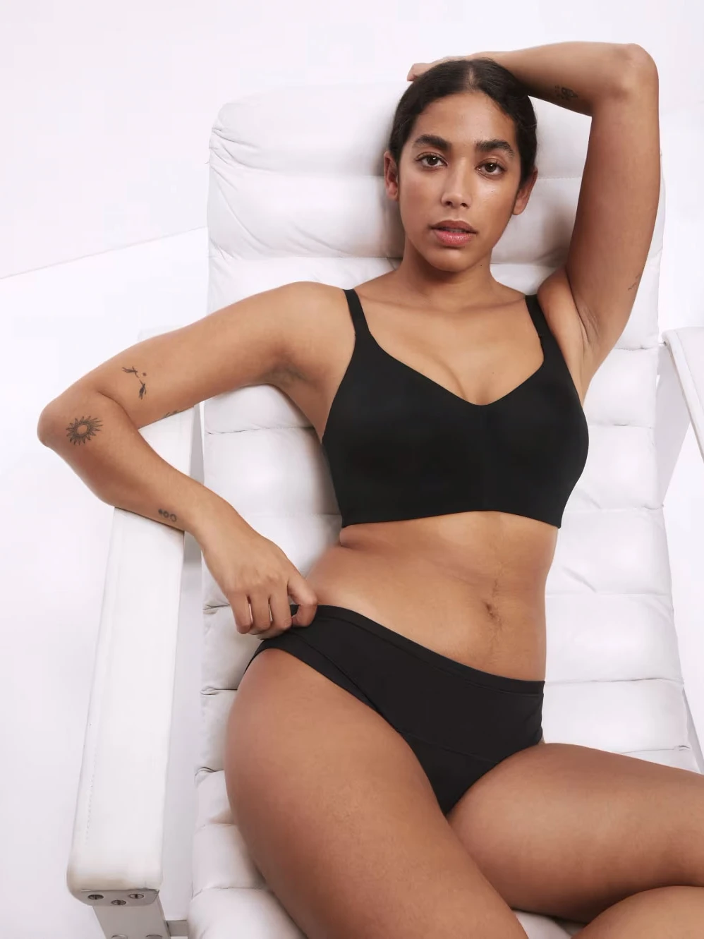 Woman wearing black bra and matching black period knickers