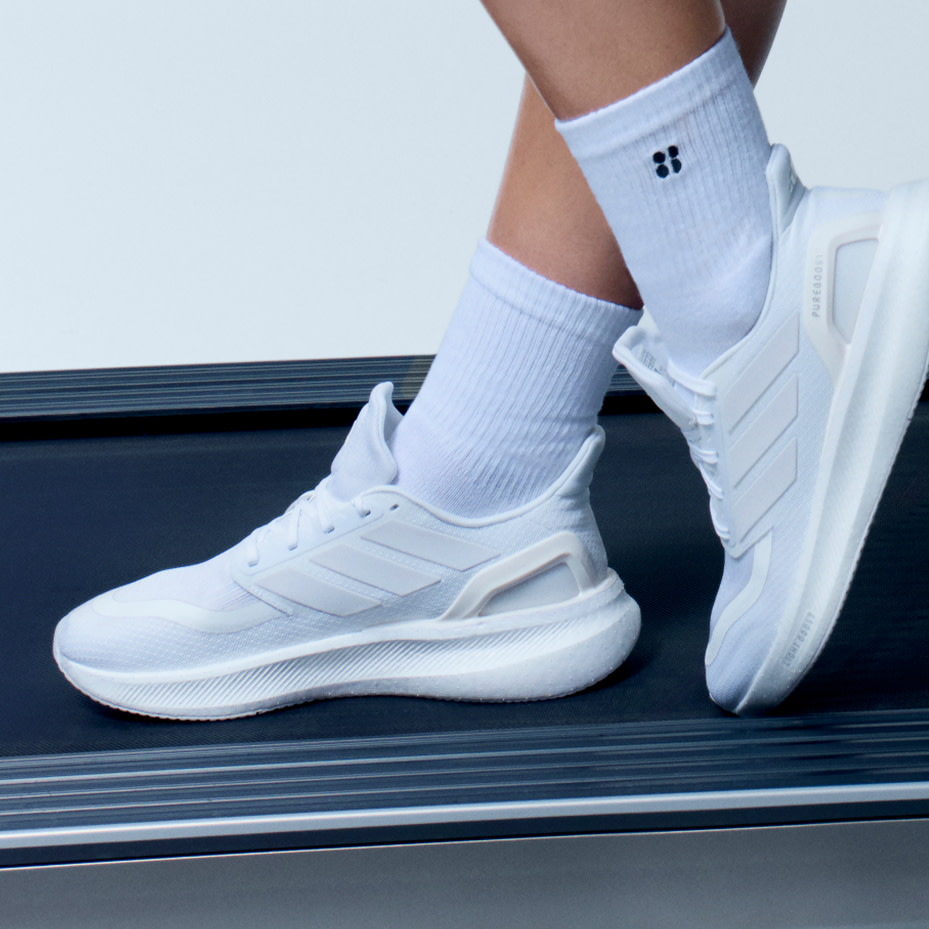 Woman wearing white trainers and white sports socks