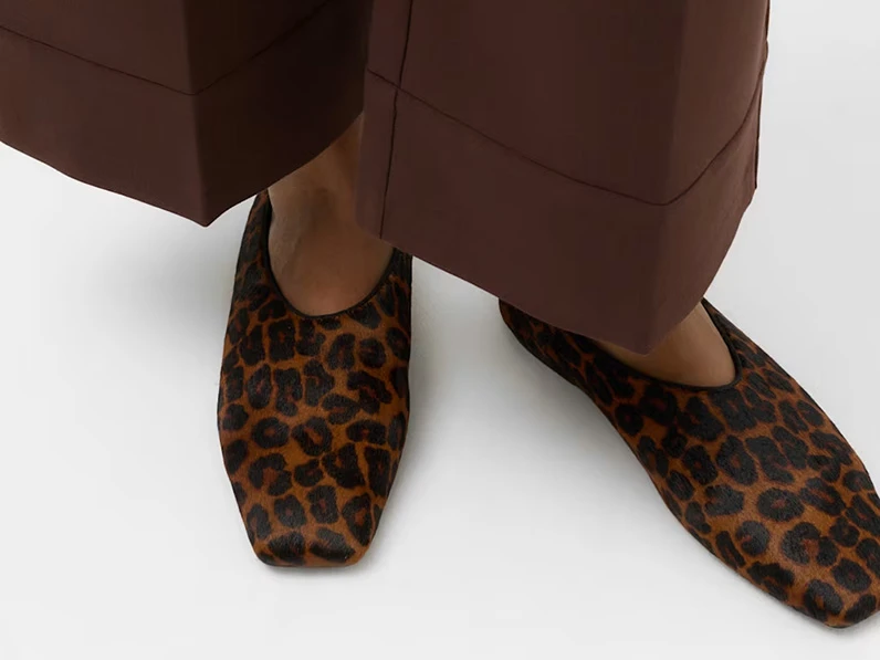 Leopard print ballet flats with a hair-on leather texture.
