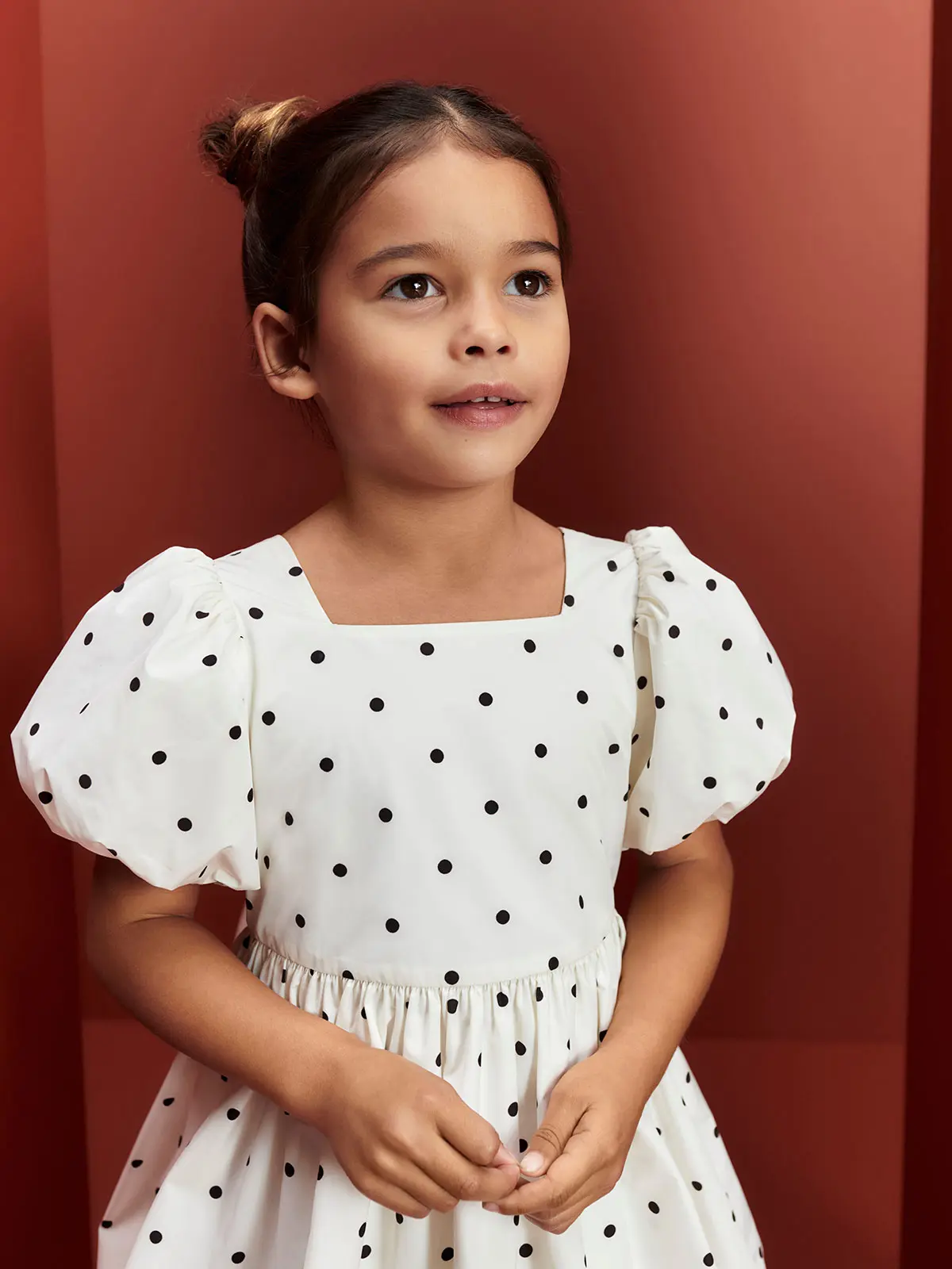 Girl in black and white polka-dot dress 