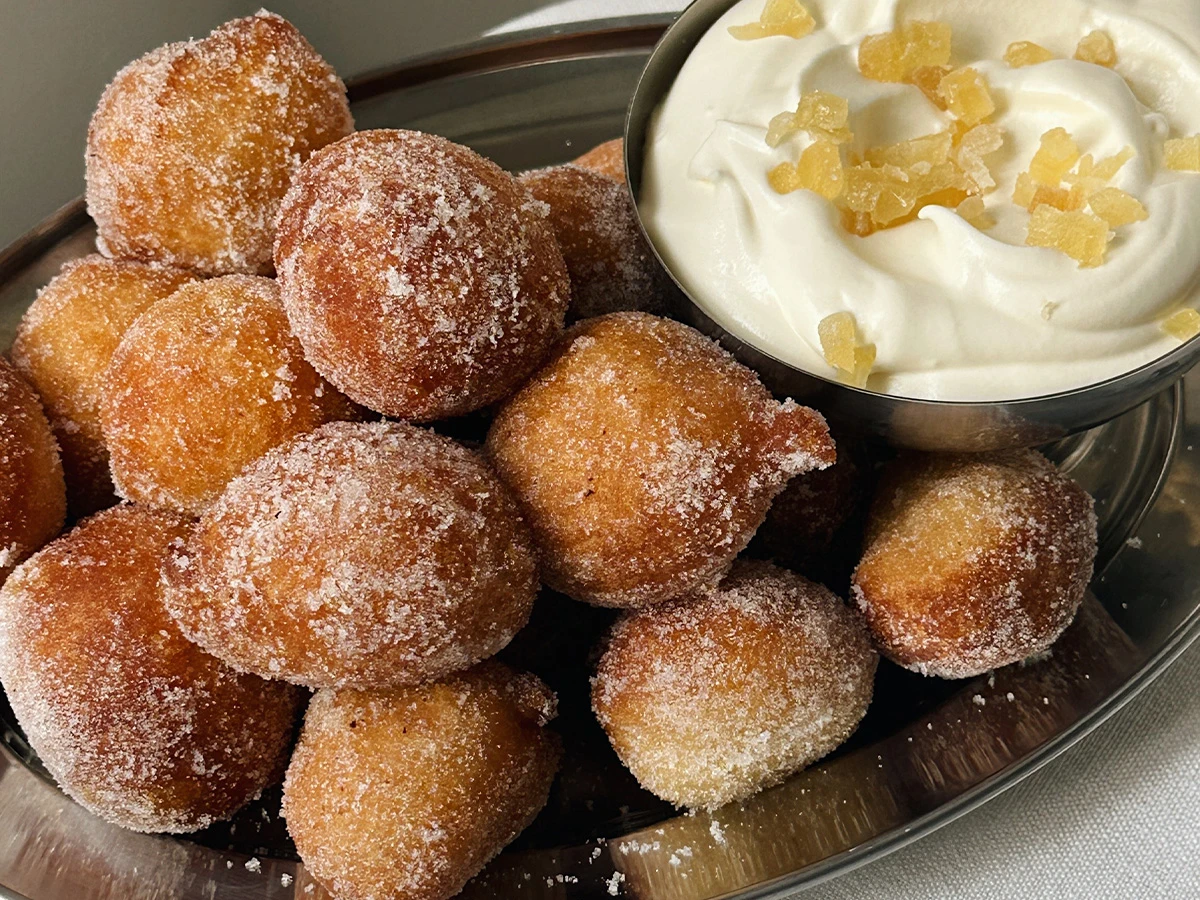 Puff puff on silver tray with ginger cream