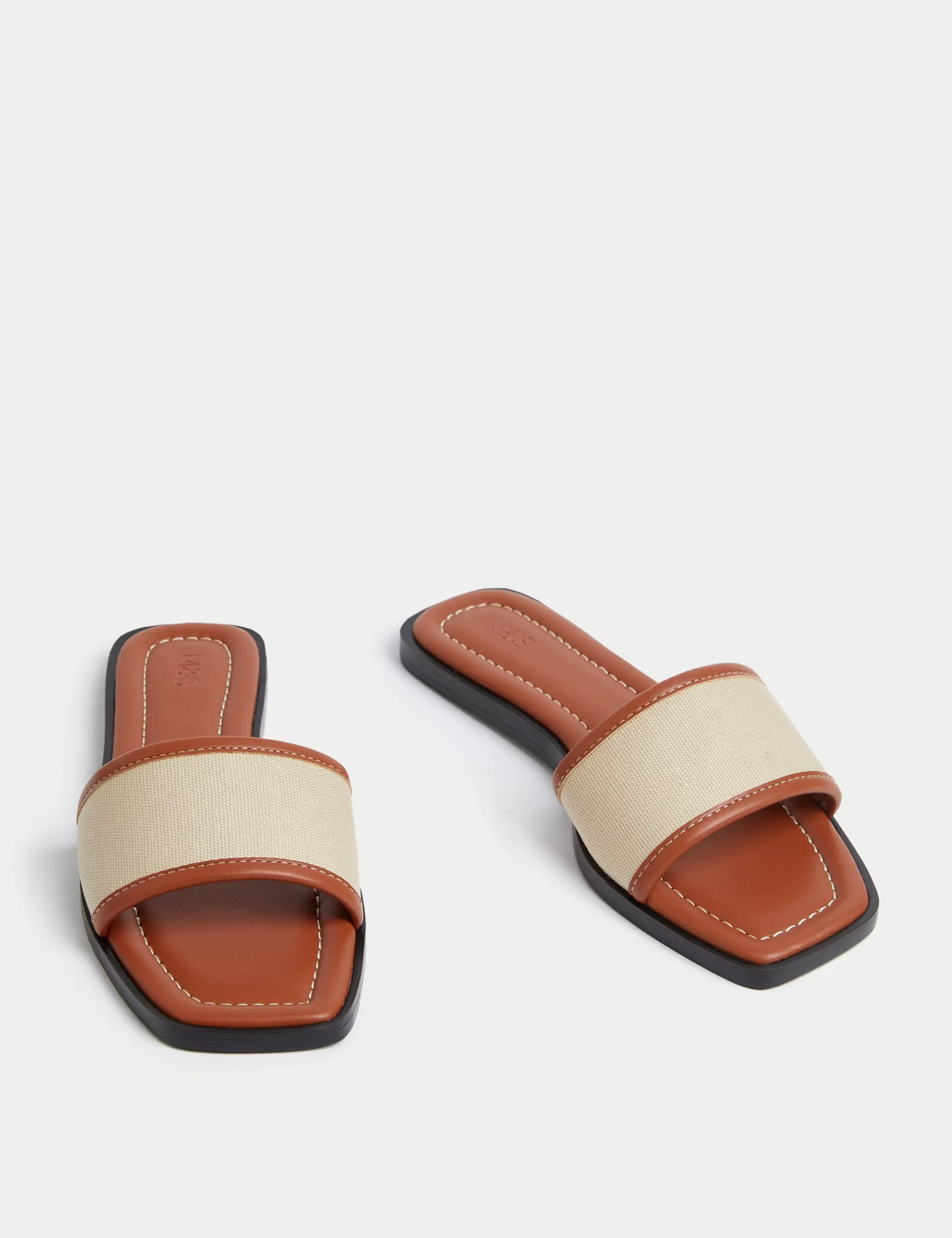 A pair of canvas slip on mules