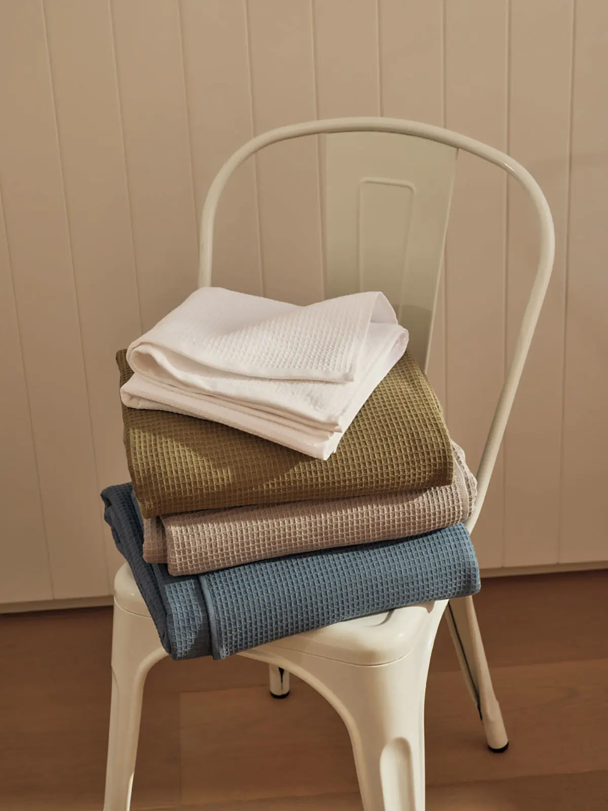 Stack of bathroom towels on chair