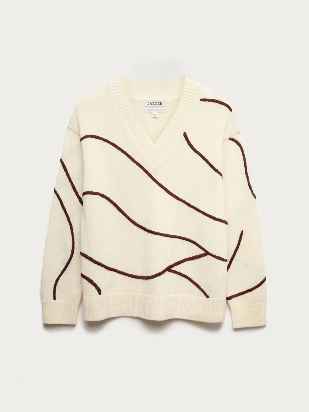 A cutout of a cream and burgundy swirly stripe jumper