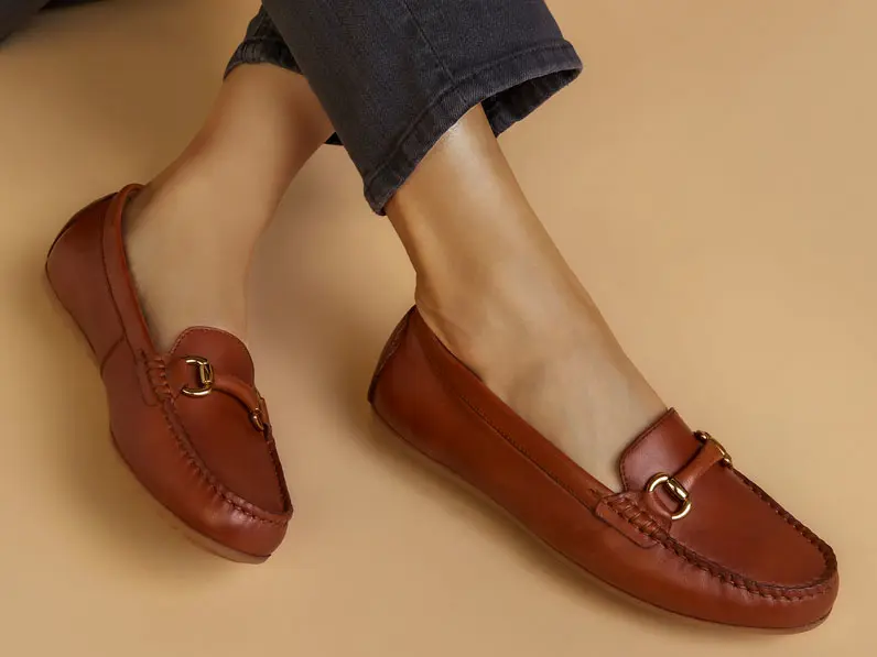Woman wearing tan loafers