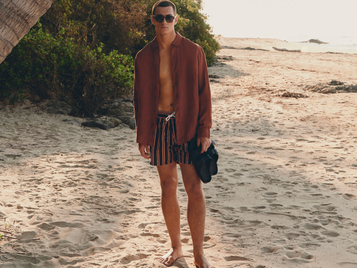 Man wearing shirt and striped swim shorts