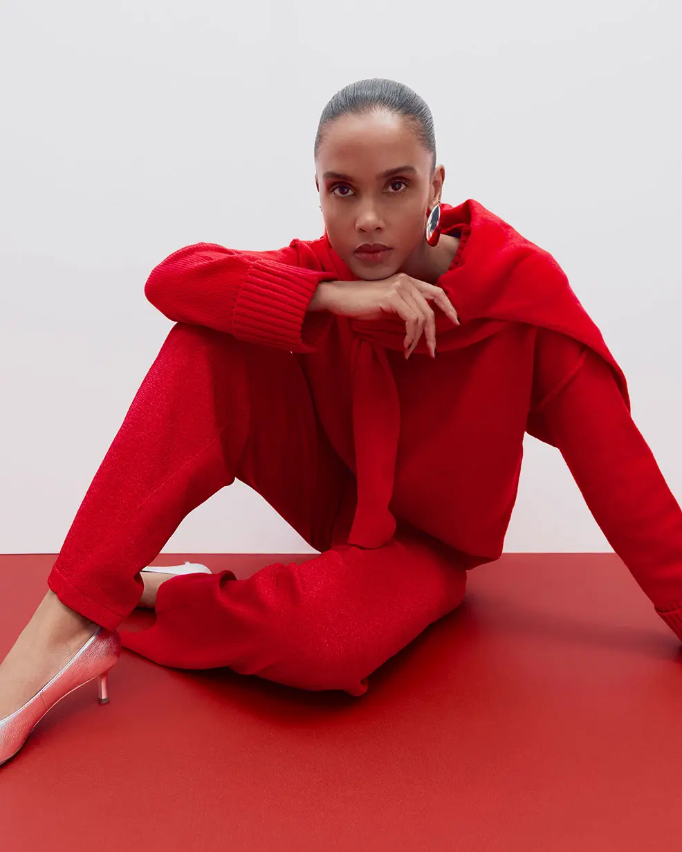 Woman wearing red trousers and jumper at M&S