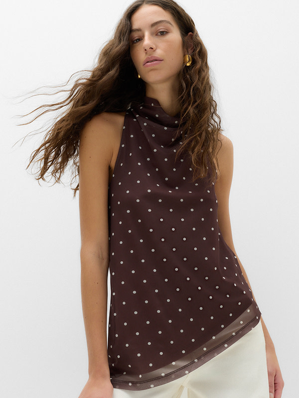 Woman in brown polka dot top