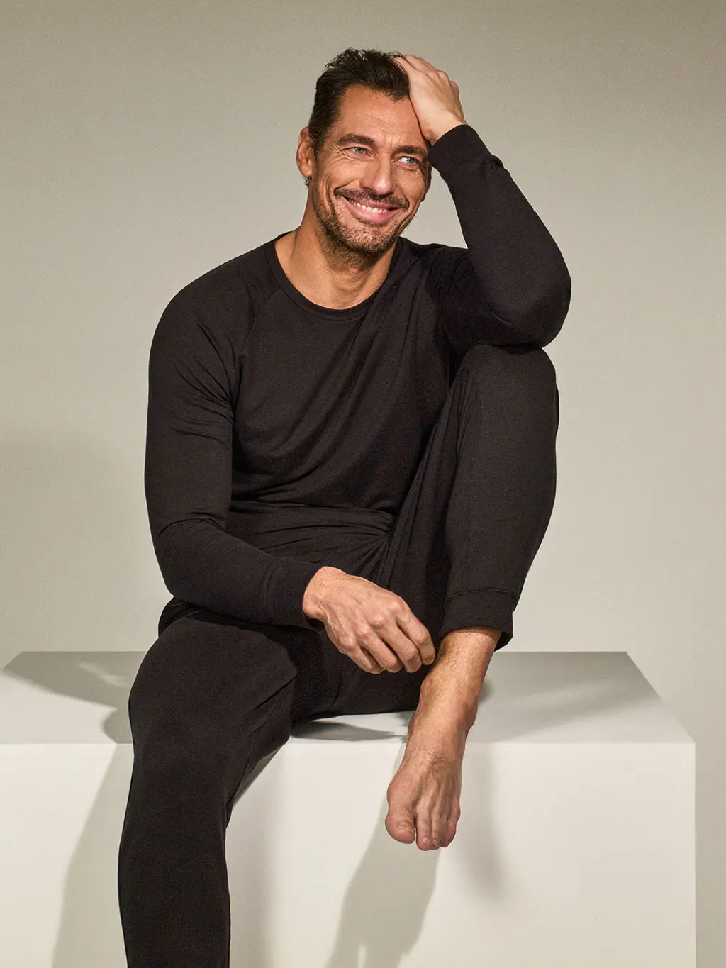 David Gandy wearing a black long-sleeved T-shirt with trousers
