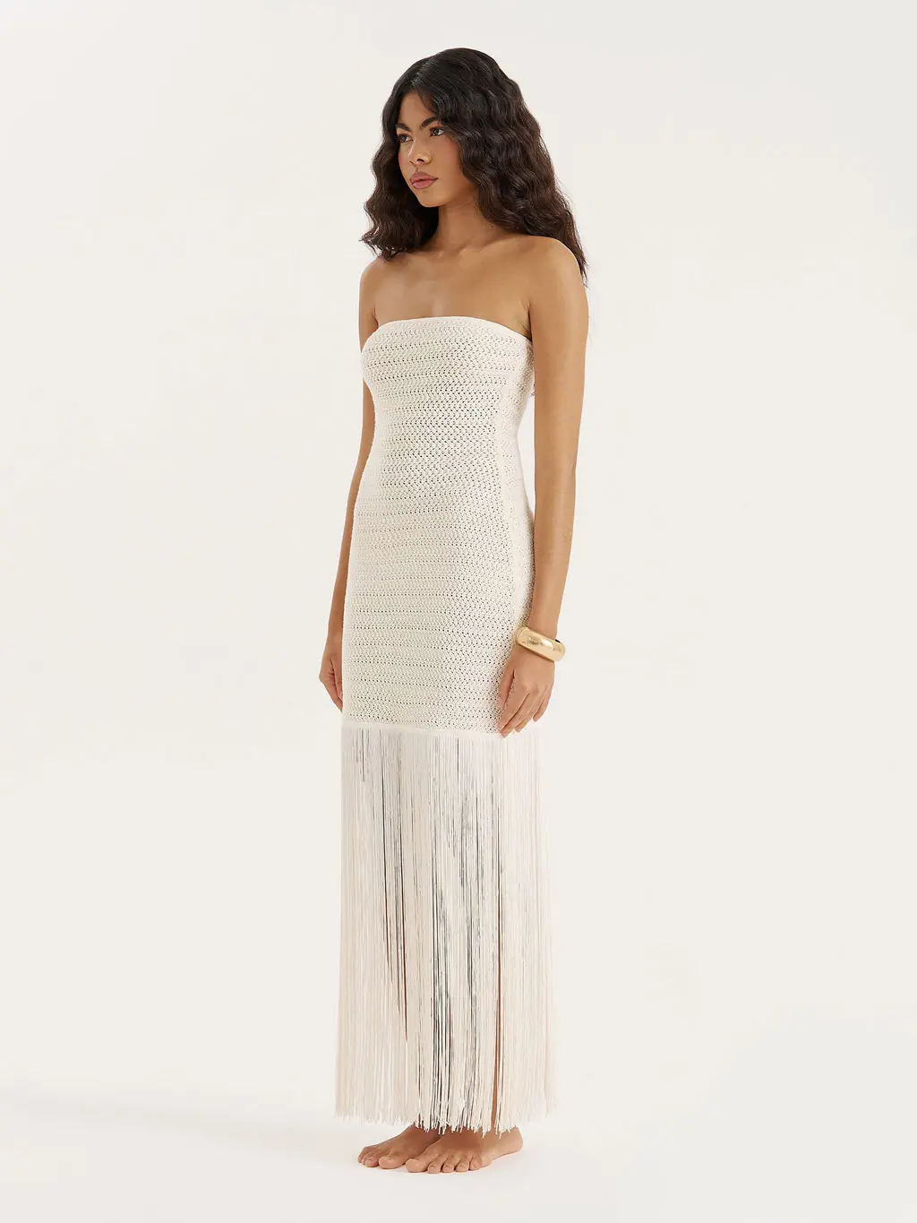 Woman wearing a fringed knitted beach dress