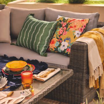 Patterned cushions on an outdoor sofa. Shop homeware