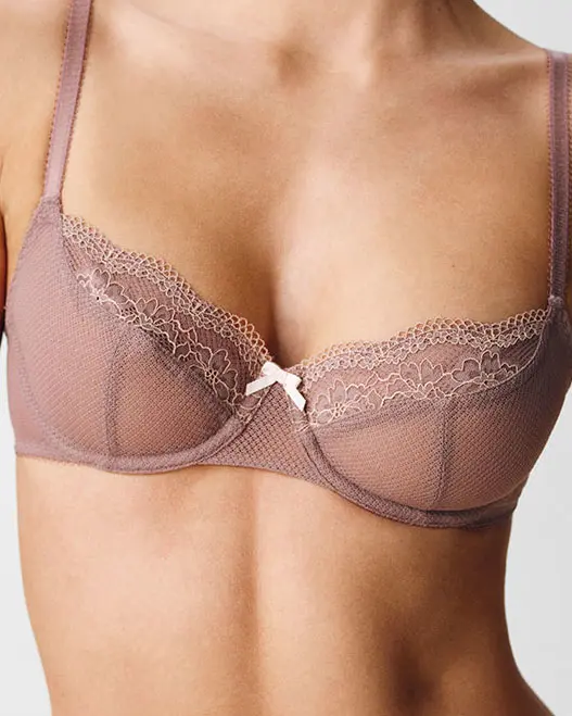 Woman wearing pink lace balcony bra