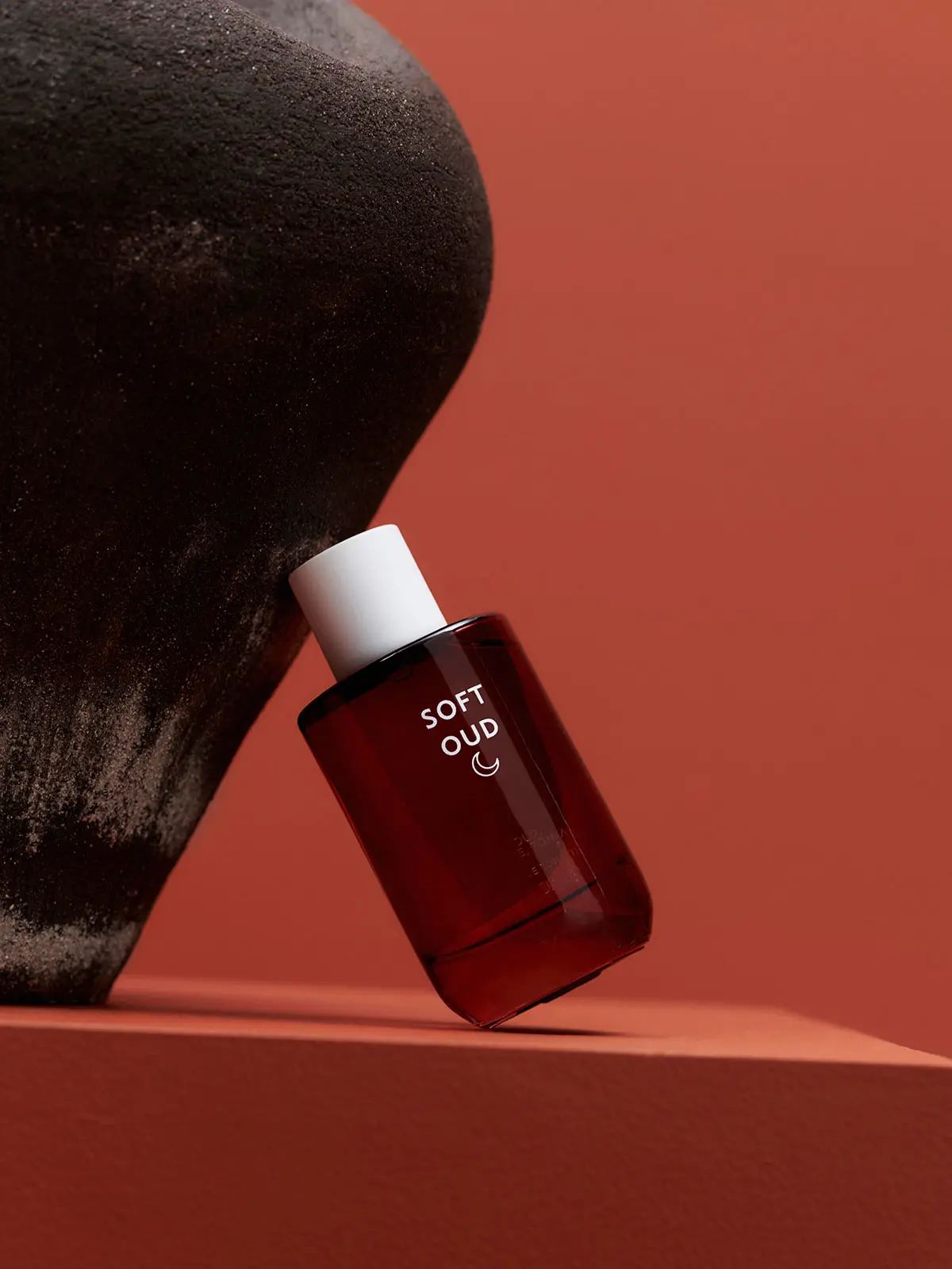 Fragrance in red bottle with white cap