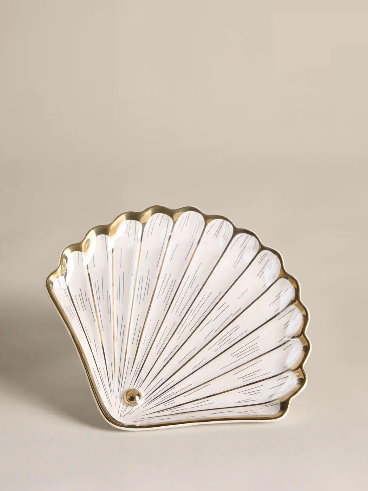 White shell-shaped platter with gold details