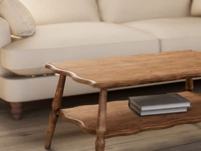 Image of a wooden coffee table next to a white sofa. Shop coffee tables