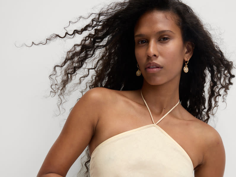 Woman wearing a cream halterneck top