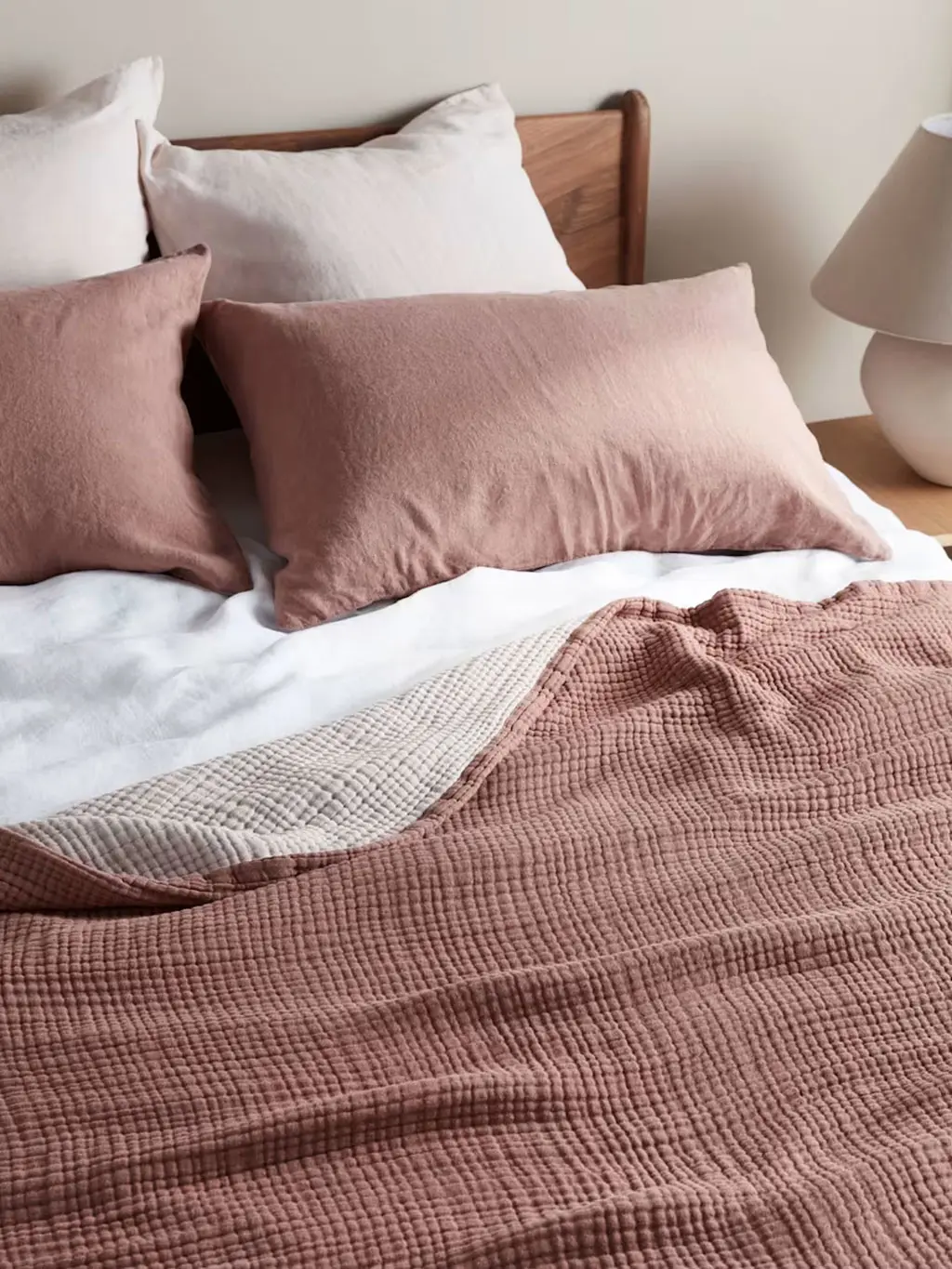 Bed dressed with a large waffle-textured throw
