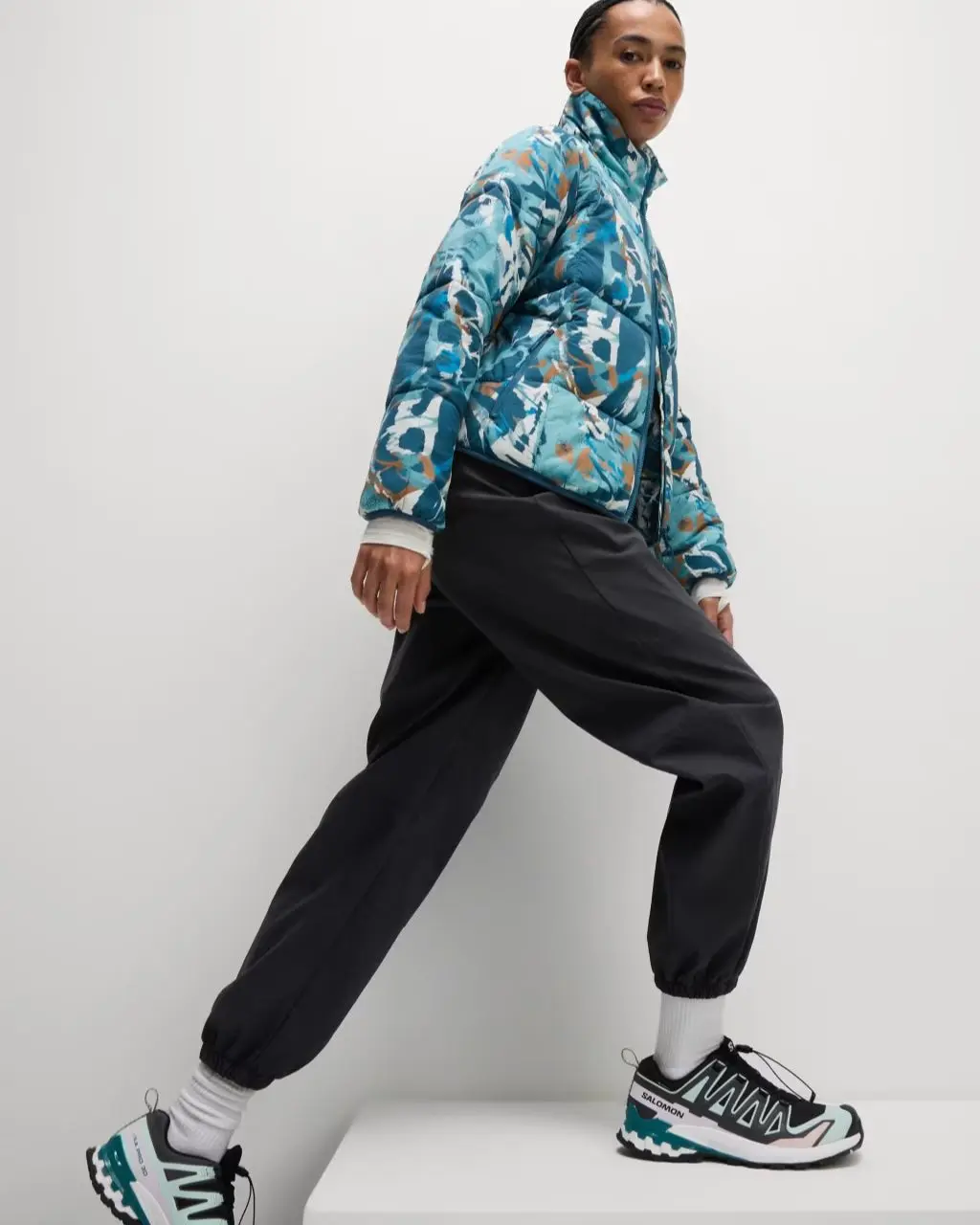 A woman wearing walking trousers, a Good Move jacket and trainers
