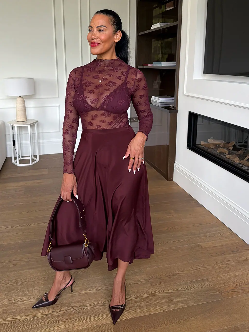 Karen Williams in lace bodysuit and burgundy skirt