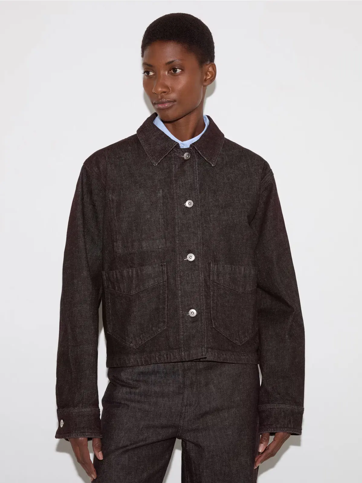 Woman wearing dark brown denim jacket