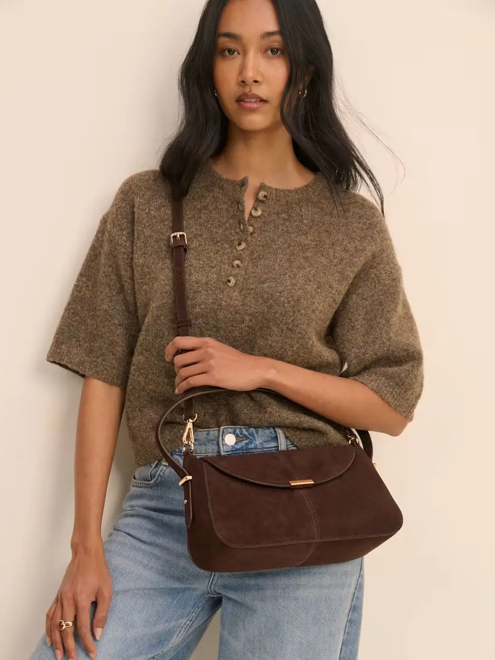 Woman in jumper and jeans with cross-body bag