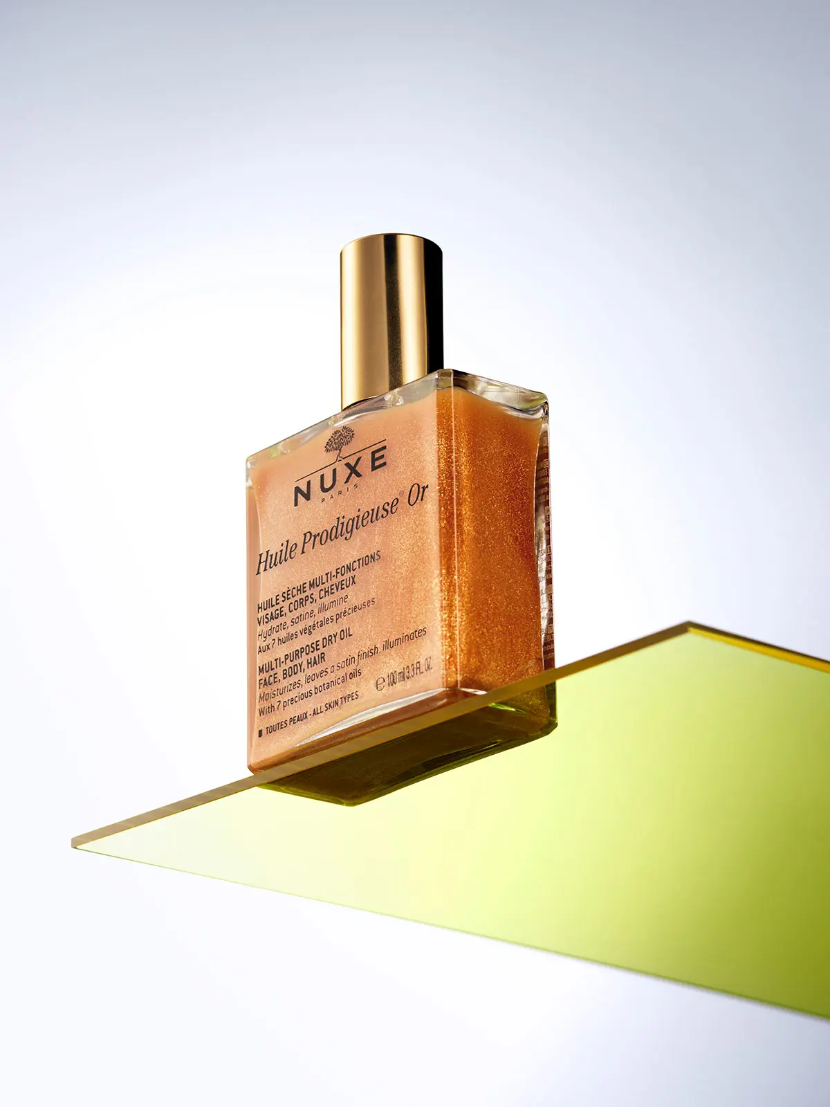 Nuxe beauty product in square bottle with gold lid