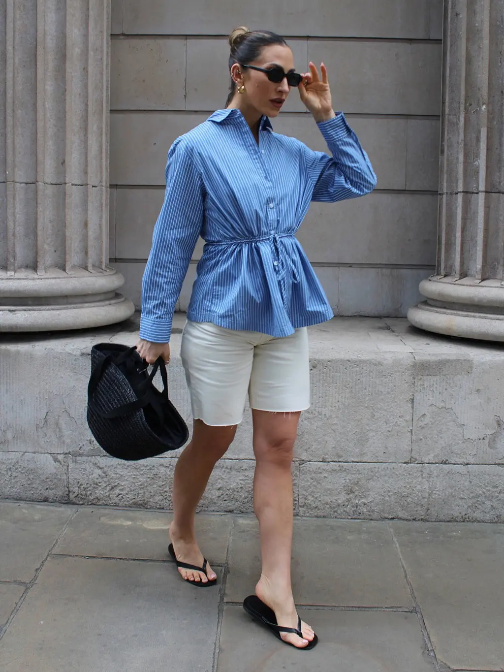 Woman in blue shirt and white shorts