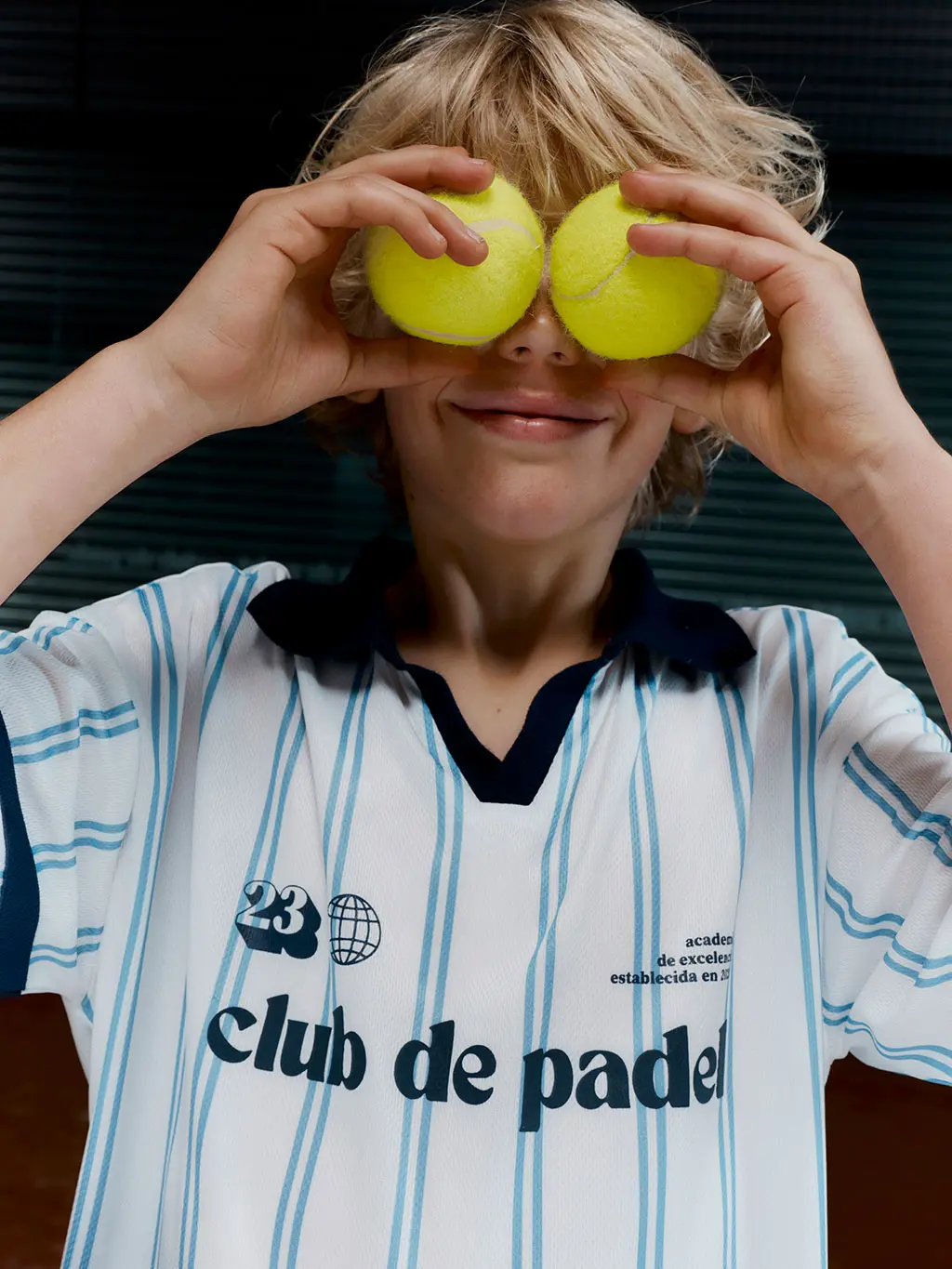 Boy holding padel balls