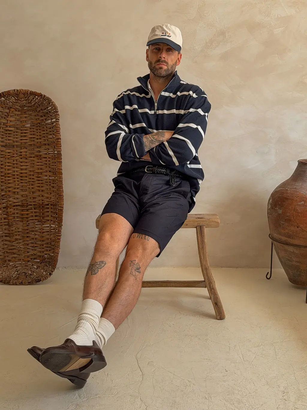 Man wearing shorts sitting on stool