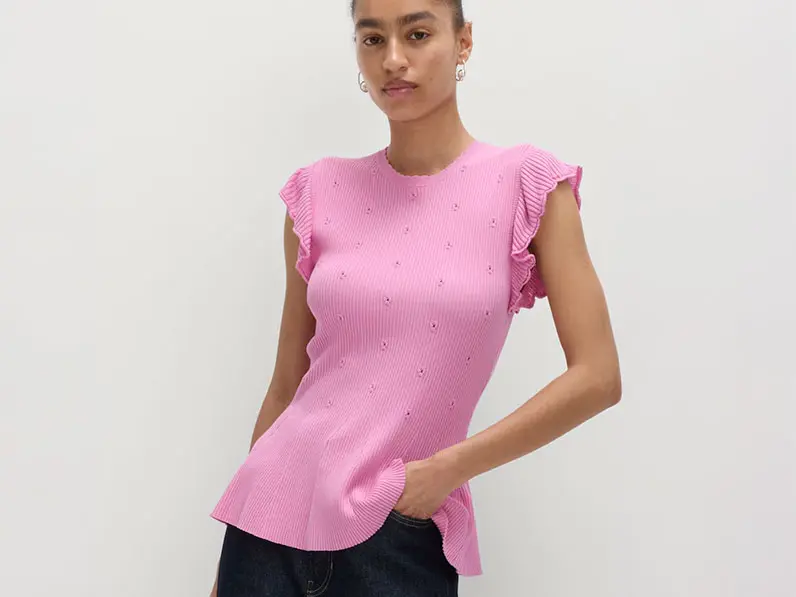 Women wearing a pink peplum knitted top