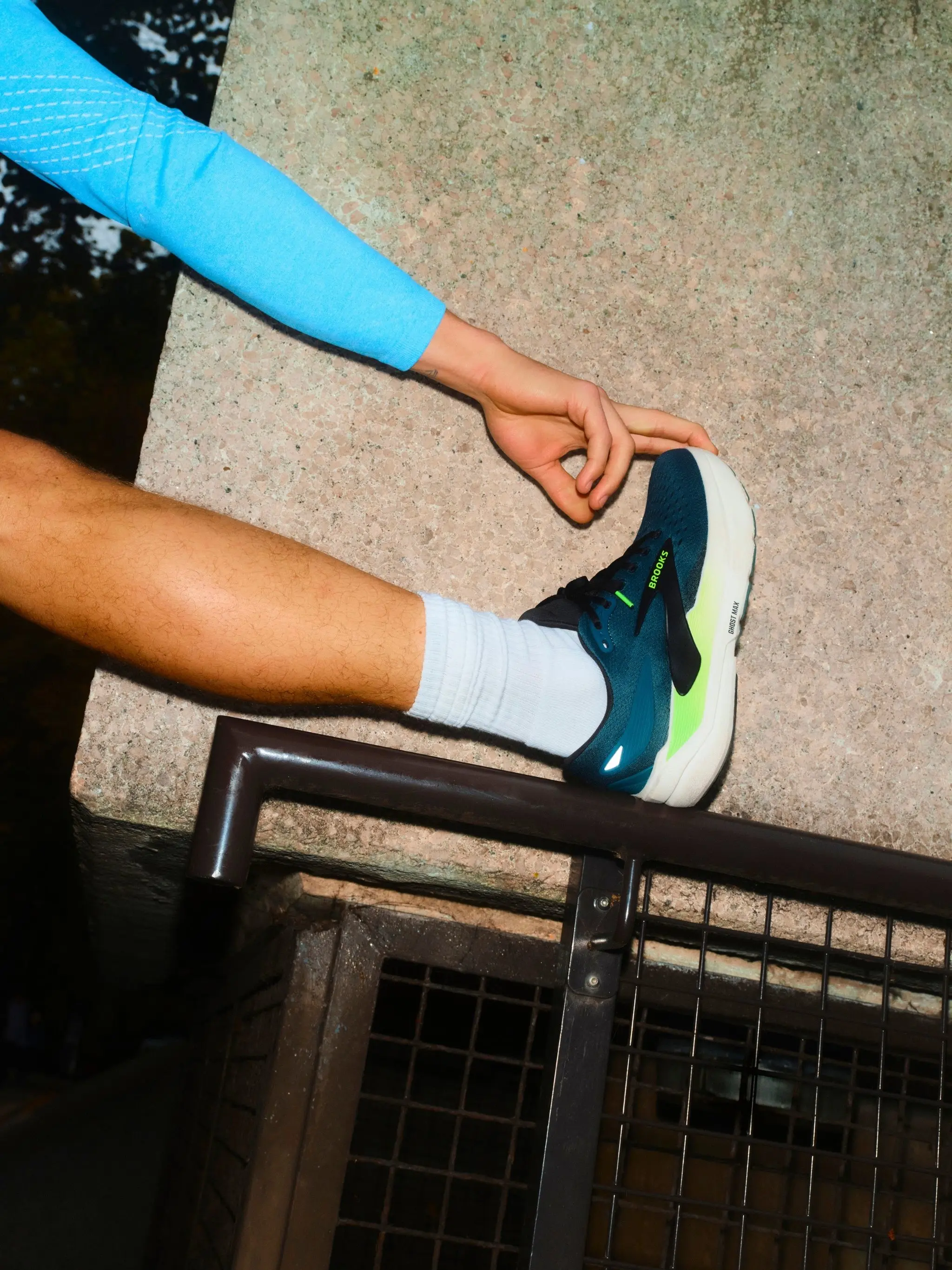 Man wearing sports trainer and stretching